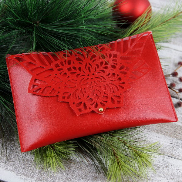 Cut & Sew - image features: Poinsettia Clutch surrounded by pine and Christmas ornaments
