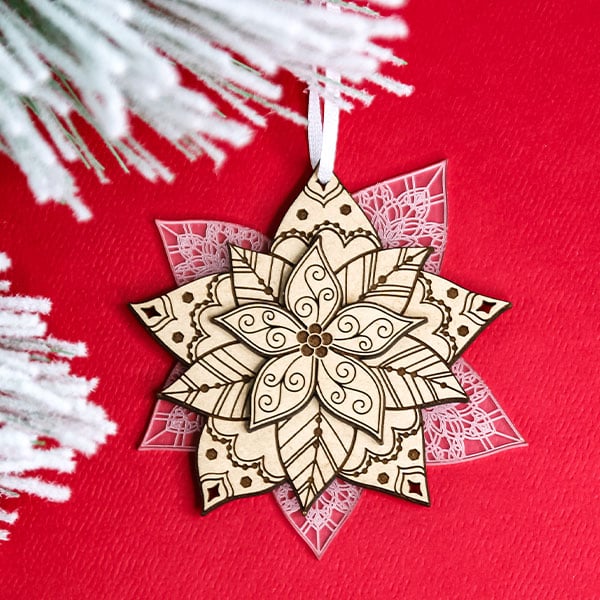 Ornaments - image features: Laser cut poinsettia surrounded by Christmas pine