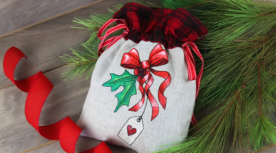 Embroidered Drawstring Gift Bag - Image features: Mistletoe with ribbon design on a linen gift bag