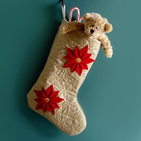 Qulting - edge-to-edge presents and freestanding poinsettia on stocking with teddy bear peeking out