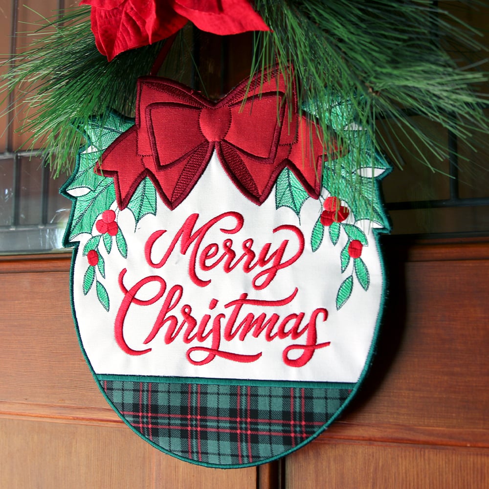 Fabric welcome sign tutorial - image features: Merry Christmas design on door with pine and poinsettia leaves
