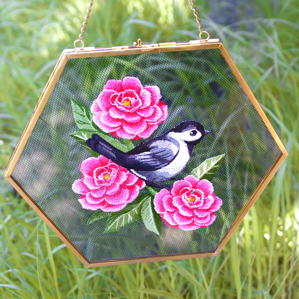 Embroidering on screens tutorial - image features: chickadee and peonies on screen in float frame