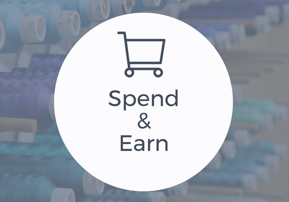 Spend & Earn - image features: shopping cart icon with machine embroidery thread 